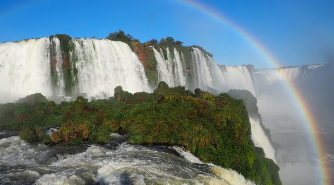 A beautiful scenery of a rainbow over a waterfall in Iguazu National Park, Cataratas, Argentina